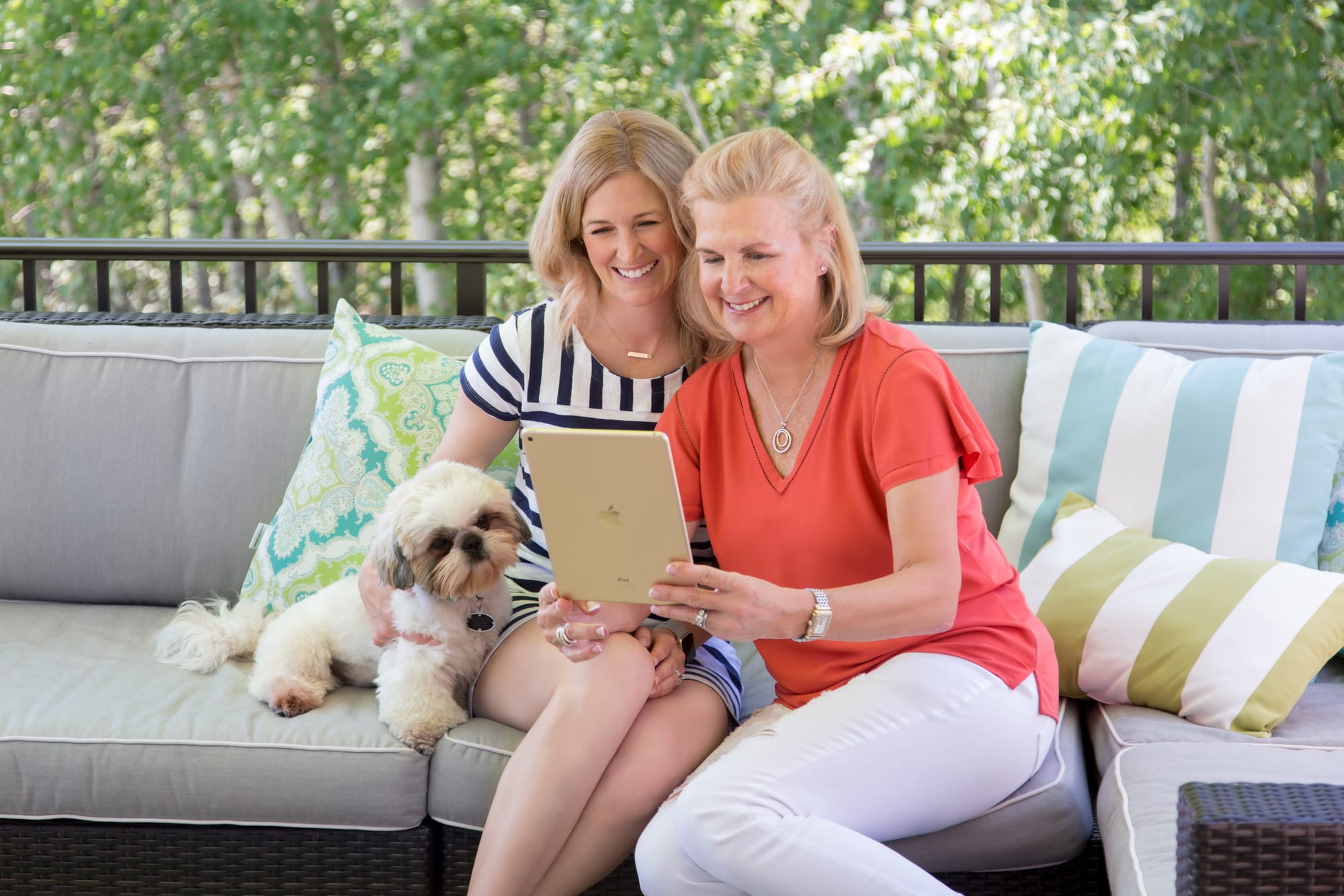 a mother and daughter with their dog watching their 8mm film conversion service complete