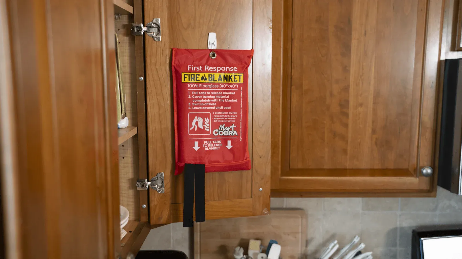 the fire blanket hung up incase there's a fire in oven what to do