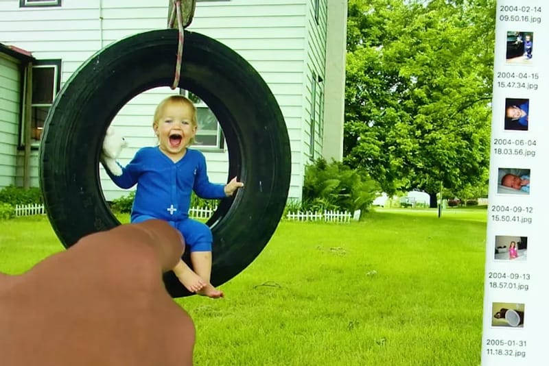 a picture of a grandchild in a tire swing